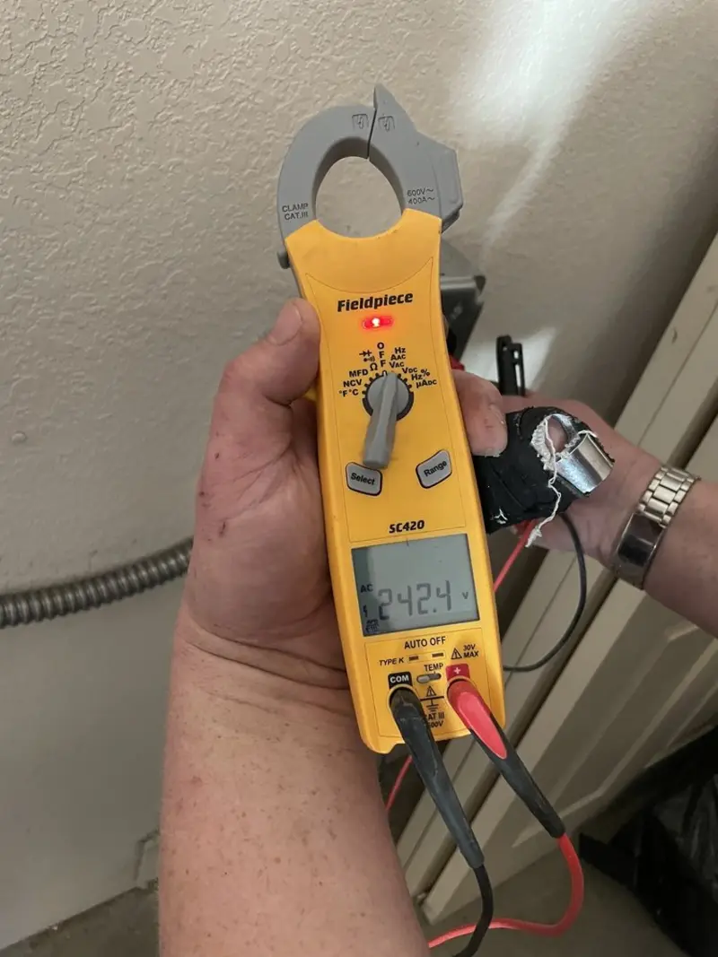 Voltage testing with clamp meter during Whole House Surge Protector in Stowe